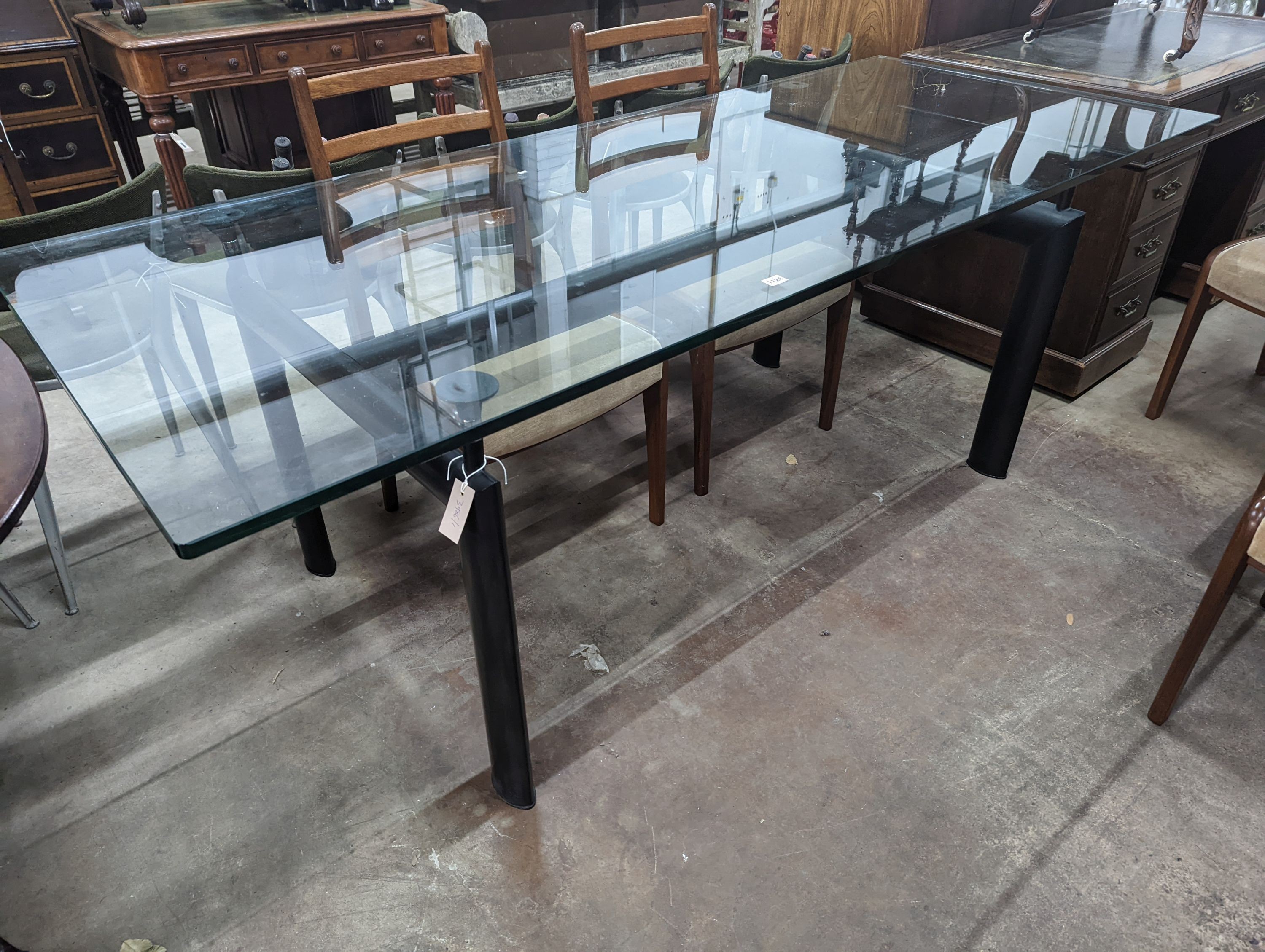 Mid century design. An LC6 style rectangular glass top dining table, length 210 cms, width 85 cms, height 74 cms.
